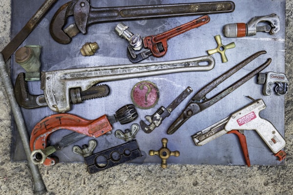 Assorted plumbing and mechanical tools arranged neatly
